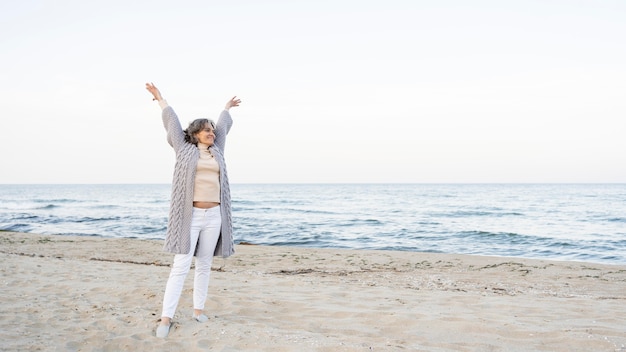 Beautiful senior woman enjoying her time at the beach