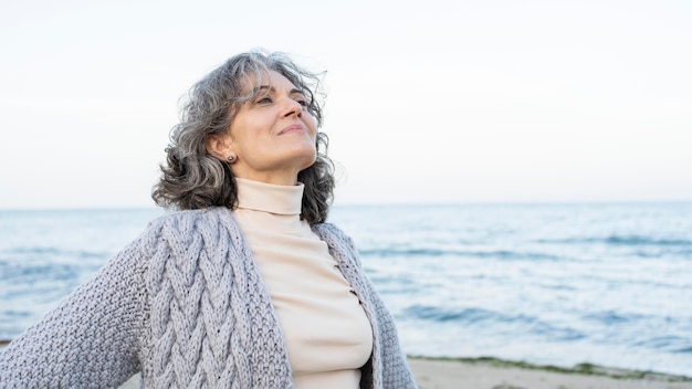 Beautiful senior woman enjoying her time at the beach