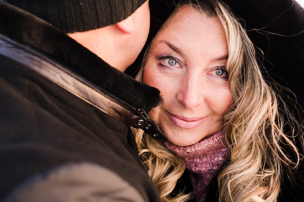 Beautiful senior woman hugging man