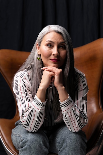 Beautiful senior woman portrait posing on chair