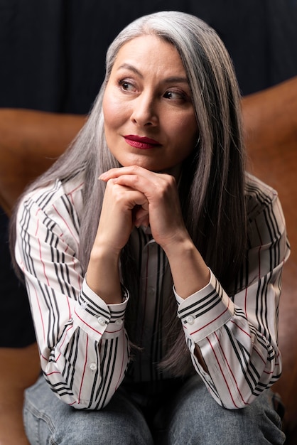 Beautiful senior woman portrait posing on chair