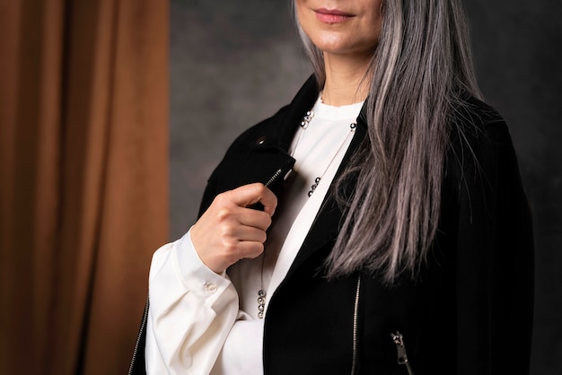 Free photo beautiful senior woman portrait wearing black jacket close up