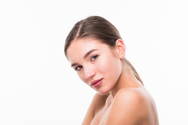 Beautiful sensual woman touching her face isolated on white wall. Beauty and skincare concept. Spa.