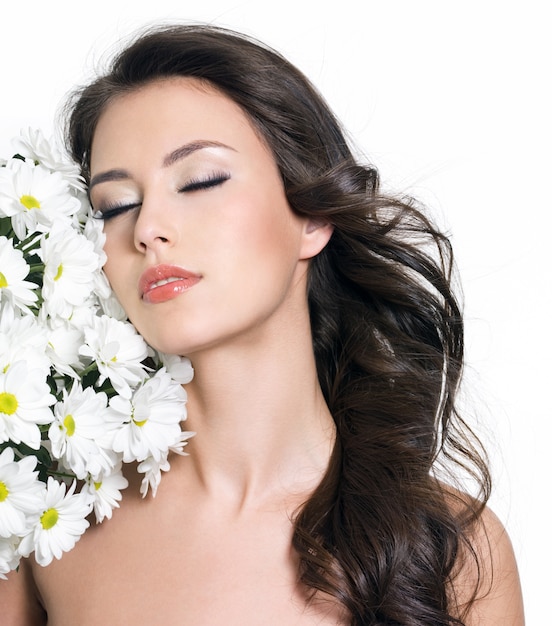 Beautiful sensuality young woman with closed eyes and white flowers - white background
