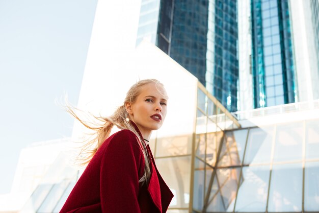 Beautiful serious caucasian woman walking outdoors.