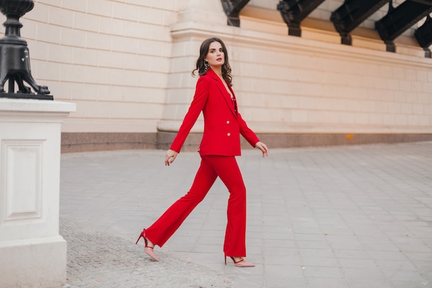 Fashion Outdoor Photo Of Beautiful Sexy Woman With Dark Hair In Elegant Red  Suit With Accessories Walking By The Street Stock Photo, Picture and  Royalty Free Image. Image 119892401.