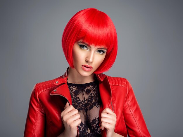 Beautiful sexy woman with bright red bob hairstyle. Fashion  model. Sensual  gorgeous girl in a leather jacket. Stunning face of a pretty lady.