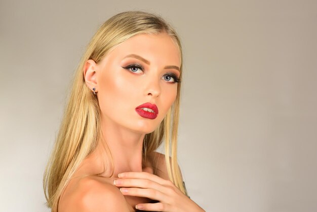 Beautiful sexy woman with red lips perfect skin and beautiful professional makeup skincare