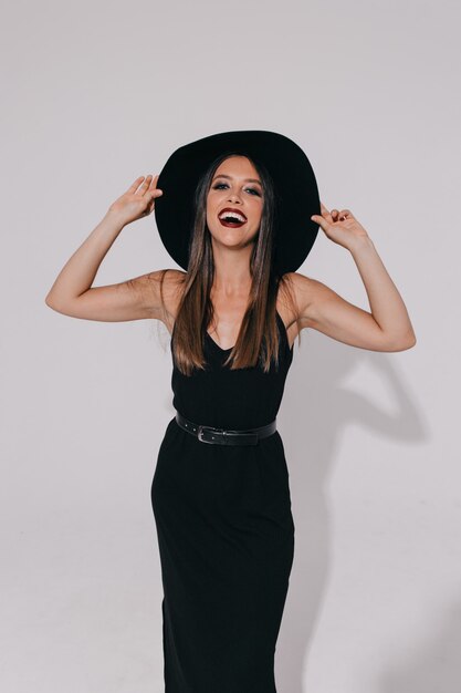 Beautiful shapely woman smiling with inspired face expression. Happy girl in black shirt smiling