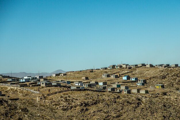 Beautiful shot of buildings on the mountain with a blue sky in the background