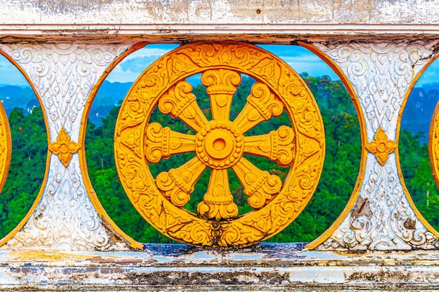 Free photo beautiful shot of the colorful stone fence of the temple in thailand with the trees behind