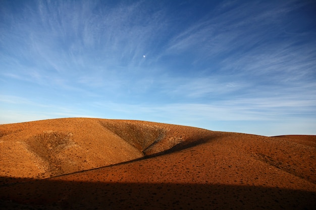 Beautiful shot of deserted hills under a blue sky at daytime