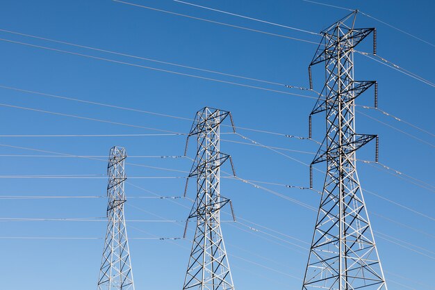 Beautiful shot of electric poles under a blue sky