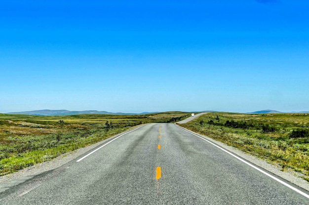 Beautiful shot of an empty road under a blue sky at daytime