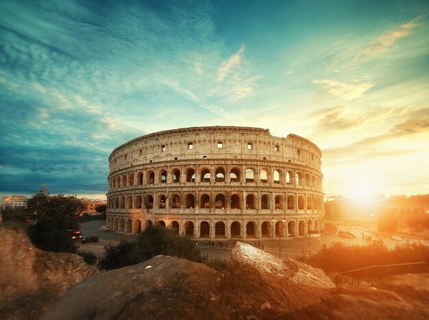 Beautiful shot of the famous Roman Colosseum amphitheater under the breathtaking sky at sunrise