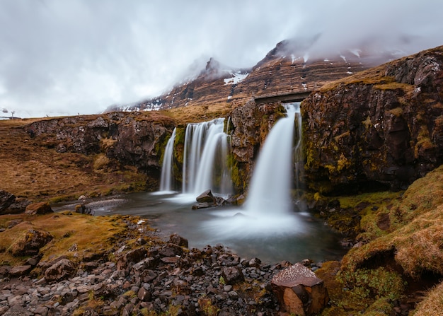 Beautiful shot of a field with waterfalls on hills