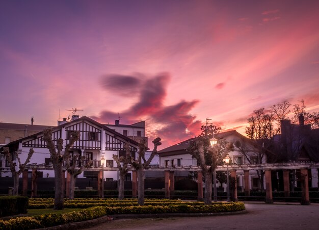 Beautiful shot of houses in Pamplona, Spain with a scenery of sunset in the background