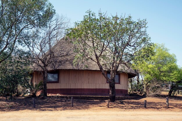 Beautiful shot of a huge african hut with a clear blue sky