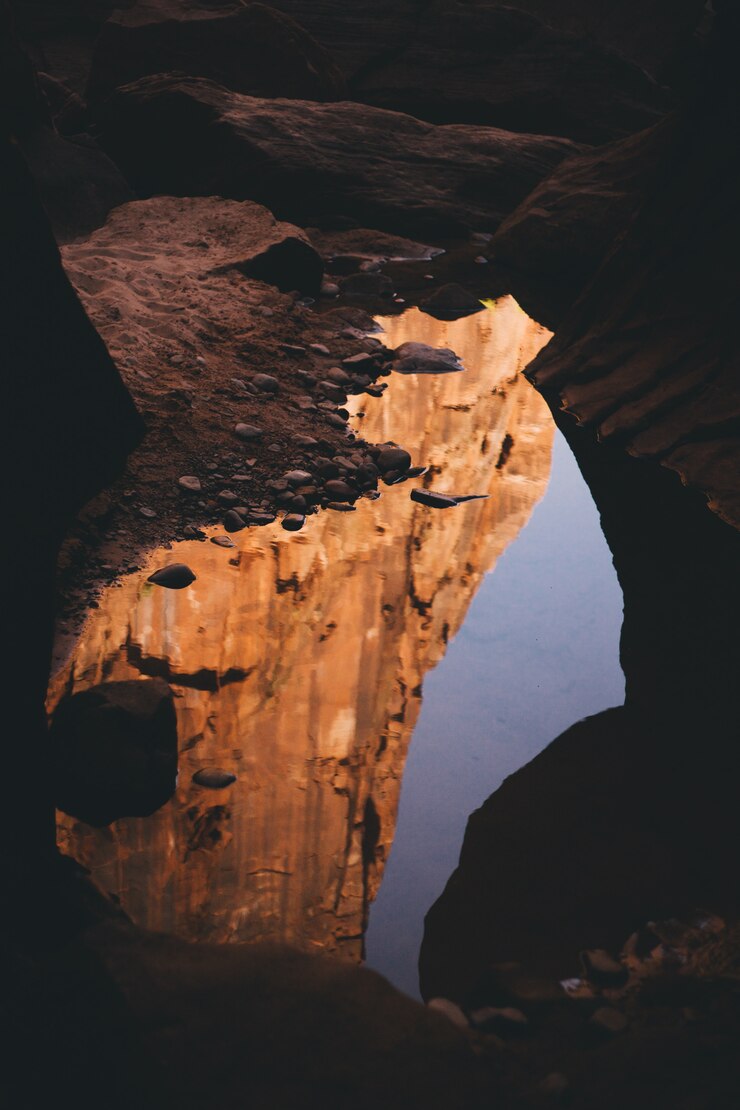 Free Photo beautiful shot of the inside of a cave with light reflecting in the water