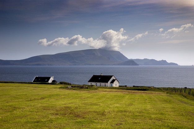 Beautiful shot of an isolated house in a valley next to the sea of County Mayo in Ireland