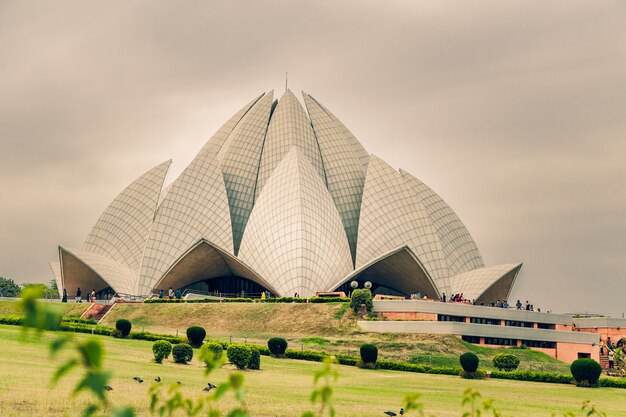 Beautiful shot of the Lotus Temple in Delhi India under a cloudy sky