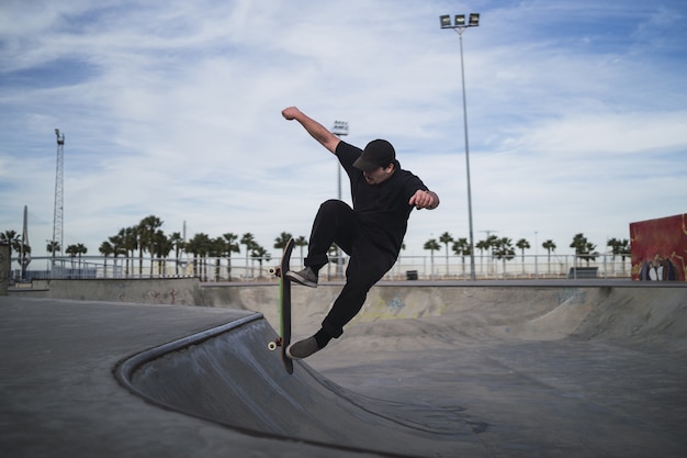 Beautiful shot of a man skateboarding in a skatepark during daytime