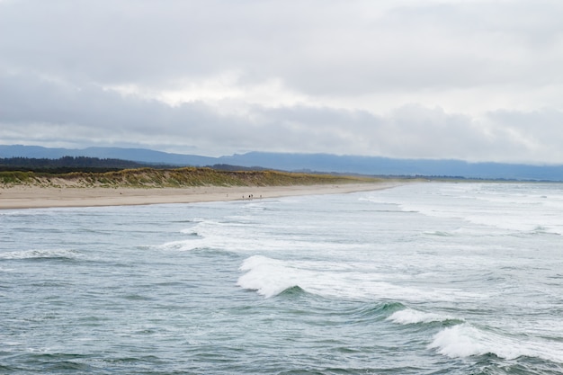 Beautiful shot of ocean waves on a gloomy cloudy day