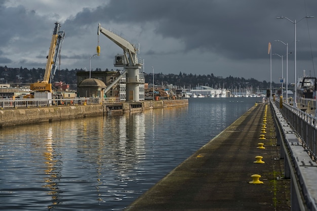 Free photo beautiful shot of a pier with a cloudy gray sky