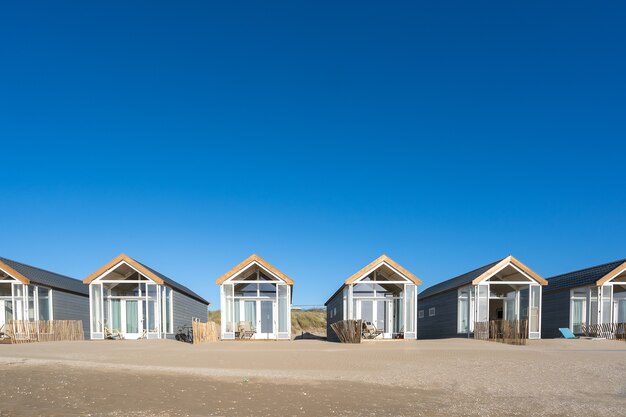 Beautiful shot of resting cabins on a sand beach