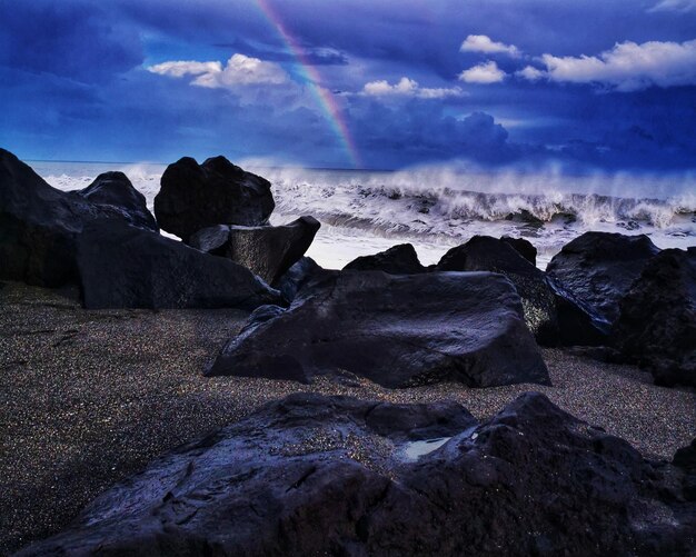 Beautiful shot of rocks by the ocean on a cloudy day