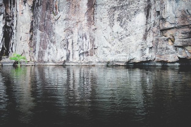 Beautiful shot of rocky cliff near a lake