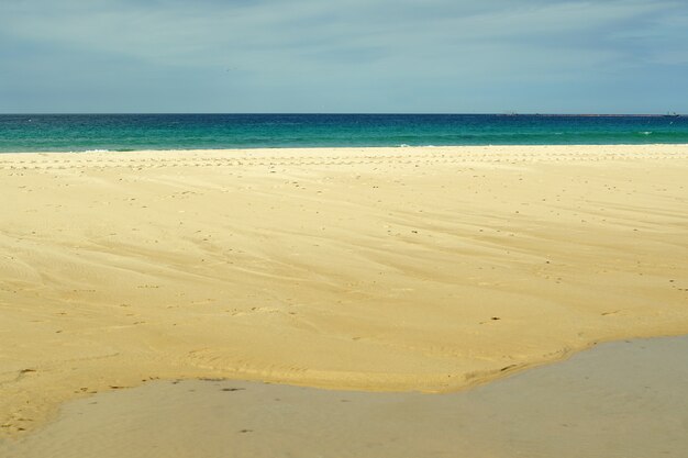 Beautiful shot of the sandy shore of Playa Chica beach in Tarifa, Spain