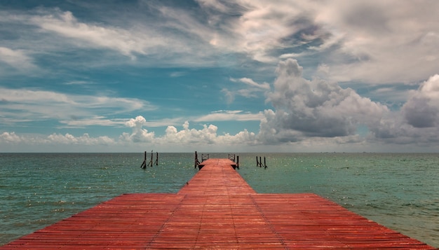 Free photo beautiful shot of a sea pier on a fascinating sky scene