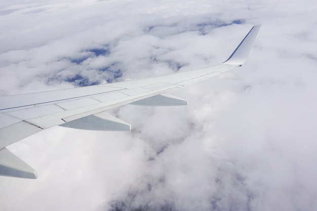 비행기 창에서 구름과 비행기 날개로 가득한 하늘의 아름다운 샷