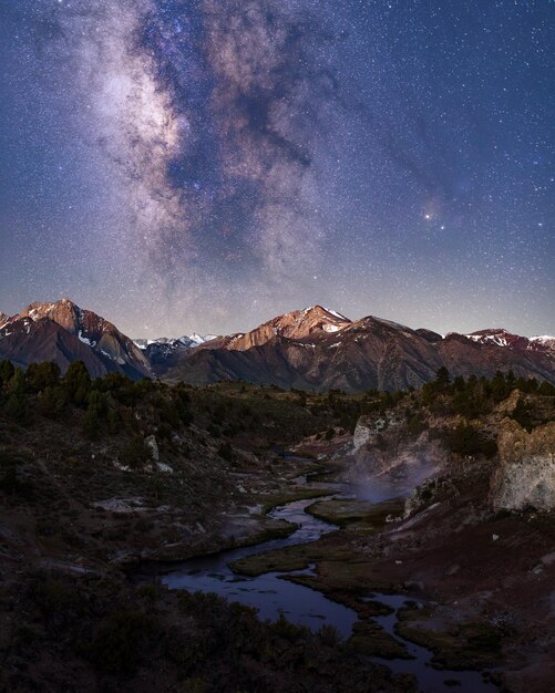 Beautiful shot of snowcovered mountains and hills with the Milky Way galaxy in a starry sky