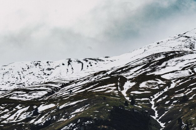 Beautiful shot of snowy hills with cloudy skies