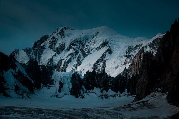 Beautiful shot of a snowy mountain with a dark blue sky