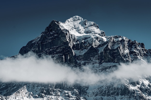 Beautiful shot of the snowy mountains surrounded by clouds