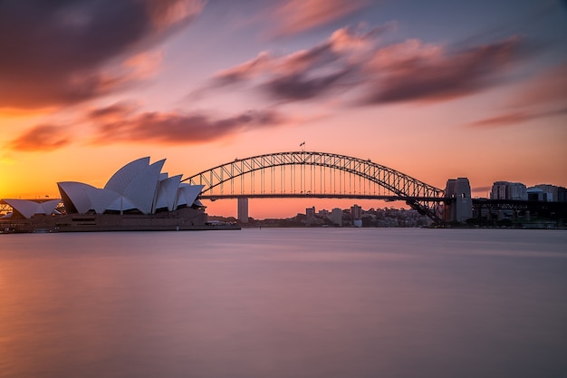 Beautiful shot of the Sydney harbor bridge with a light pink and blue sky