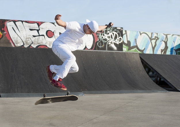 Free photo beautiful shot of a young caucasian male doing skateboard stunts