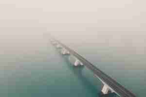 Free photo beautiful shot of the zeeland bridge covered with fog in the netherlands