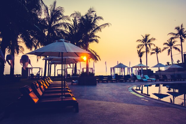 Beautiful Silhouette palm tree with umbrella and chair