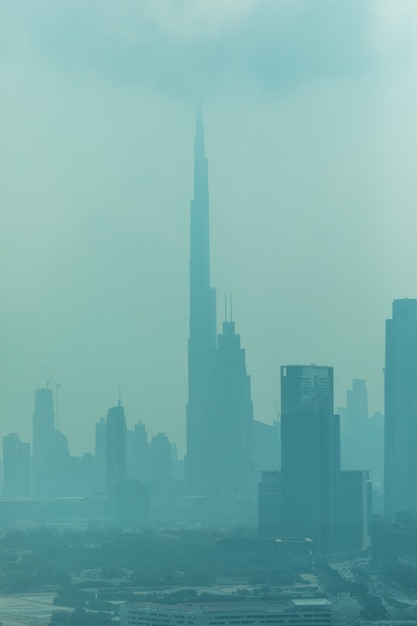 Beautiful skyline of Dubai surrounded by sand dust at day light