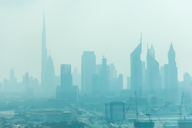 Beautiful skyline of Dubai surrounded by sand dust at day light