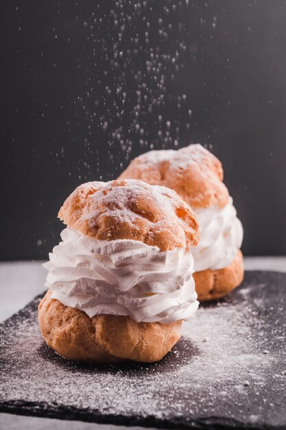 Beautiful small cakes on black table