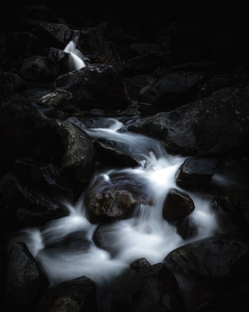 Beautiful small river running through rocks in a forest