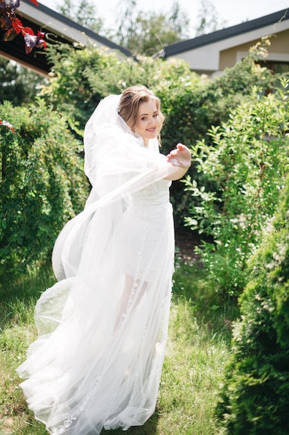 Free photo beautiful and smiling bride in the garden