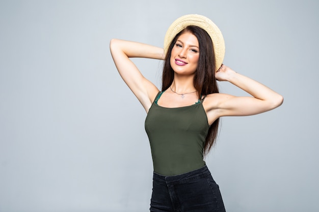 Beautiful smiling brunette woman in straw hat isolated on white