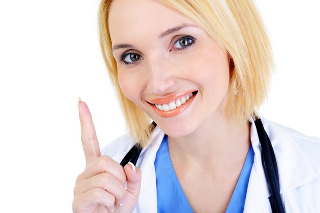 Beautiful smiling woman doctor showing forefinger