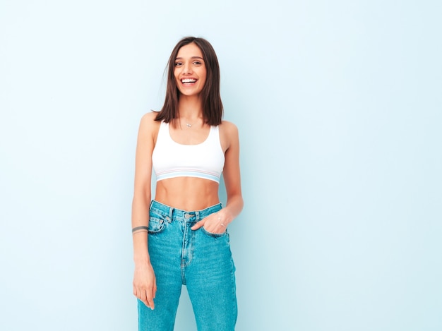 Beautiful smiling woman dressed in white jersey top shirt and jeans